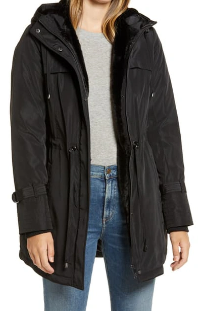 Shop Sam Edelman Faux Fur Lined Water Repellent Hooded Raincoat In Black