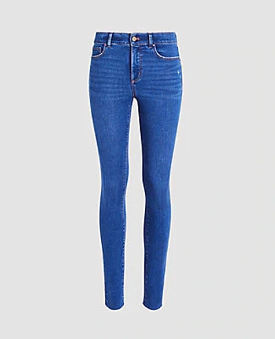 Shop Ann Taylor Sculpting Pocket Mid Rise Skinny Jeans In Mid Stone Wash