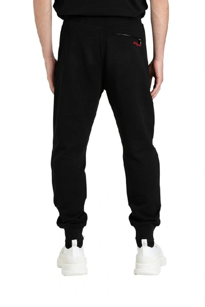 Shop Alexander Mcqueen Embroidered Logo Track Trousers In Black