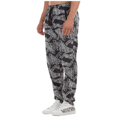 Shop Moschino All Over Logo Print Track Pants In Black