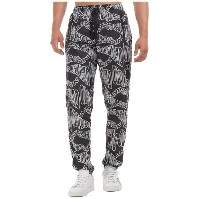 Shop Moschino All Over Logo Print Track Pants In Black