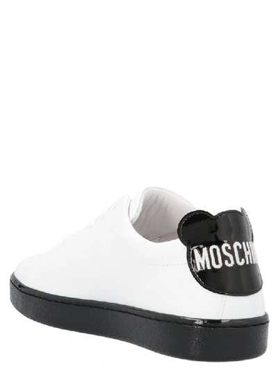 Shop Moschino Logo Embossed Sneakers In White