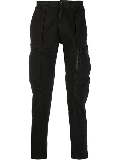 C.P. COMPANY MULTI-POCKET LENS DETAIL TROUSERS 