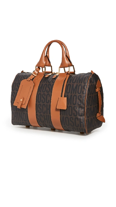 Shop Moschino Logo Print Travel Bag In Brown