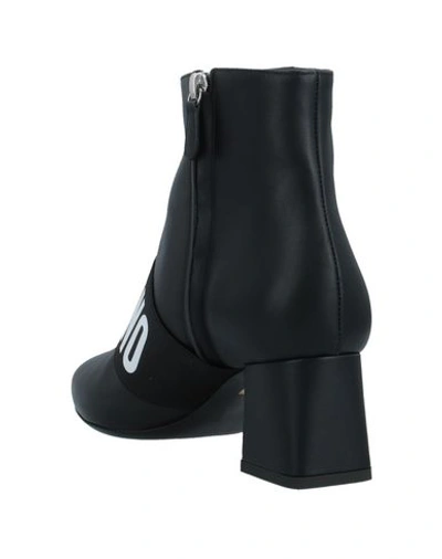 Shop Moschino Ankle Boots In Black