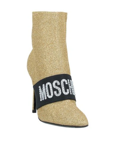 Shop Moschino Ankle Boots In Gold
