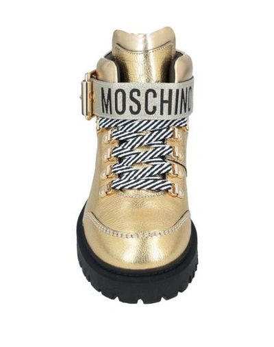 Shop Moschino Ankle Boots In Gold