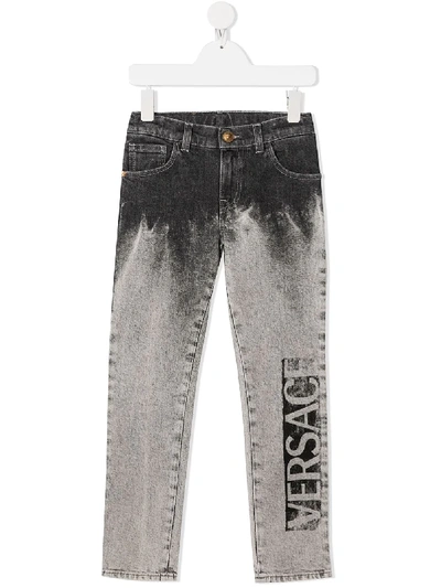 Shop Young Versace Logo Light-wash Jeans In Grey
