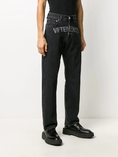 Shop Vetements Logo Print Jeans In Black