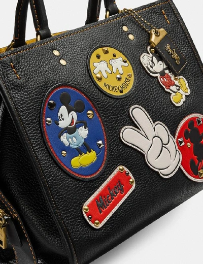 Shop Coach Disney X Rogue With Patches - Women's In Brass/black