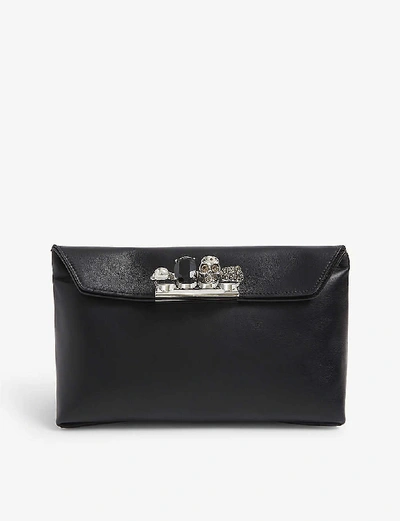 Shop Alexander Mcqueen Four-ring Skull-embellished Leather Pouch In Black