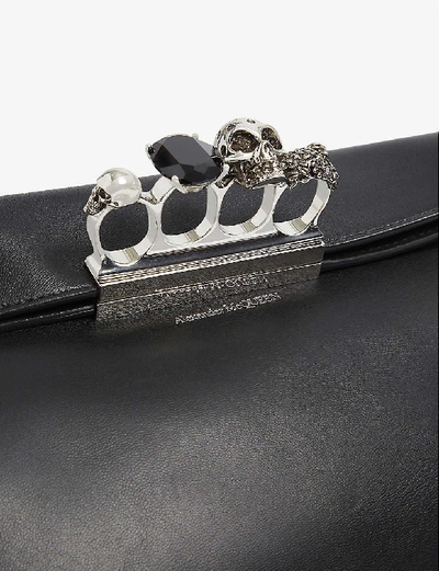 Shop Alexander Mcqueen Four-ring Skull-embellished Leather Pouch In Black