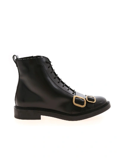 Shop Tod's Low Black Ankle Boots Featuring Golden Buckles