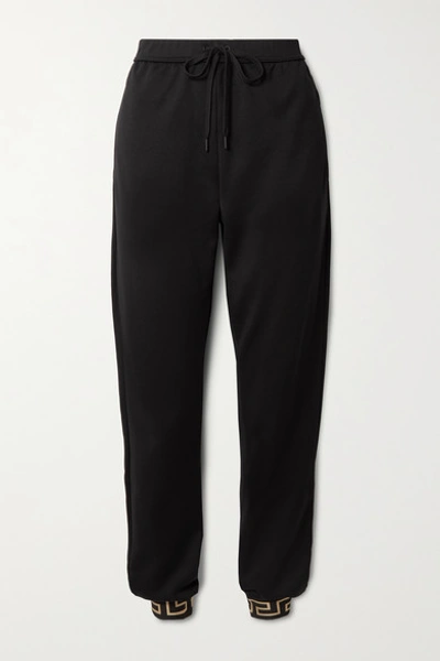 Shop Versace Printed Jersey Track Pants In Black