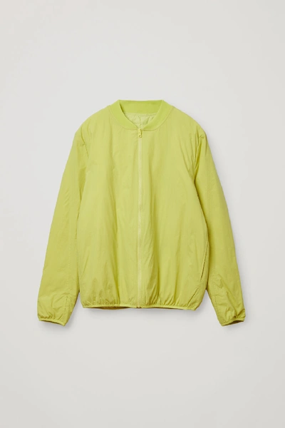 Shop Cos Recycled Polyamide Reversible Down Padded Zip-up Bomber In Yellow