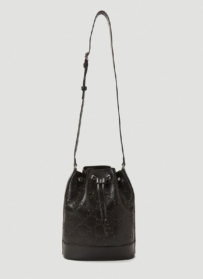 Shop Gucci Embossed Logo Bucket Bag In Black