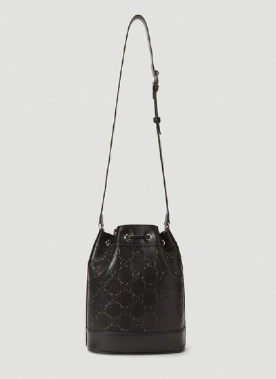 Shop Gucci Embossed Logo Bucket Bag In Black