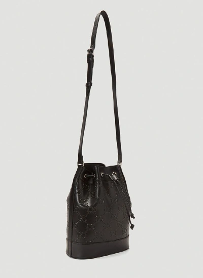 Shop Gucci Embossed Logo Bucket Bag In Black