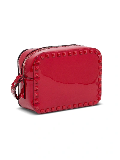 Shop Valentino Small Rockstud Crossbody Bag In Patent Leather In Red