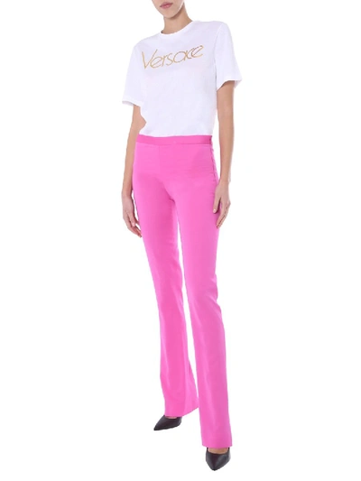Shop Versace Flared Trousers In Fuchsia