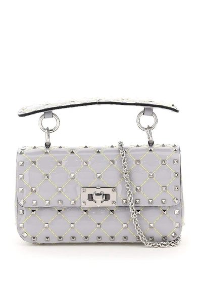 Shop Valentino Garavani Small Rockstud Spike Patent Bag In Pastel Grey Vannilla