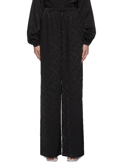 Shop Balenciaga Allover Large Logo Wide Leg Pants In Black