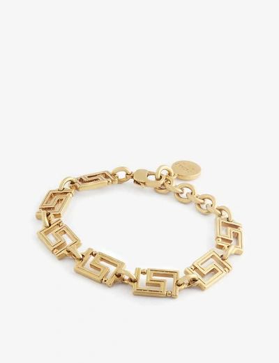 Shop Versace Grecamania Logo-engraved Bracelet In Tribute Gold