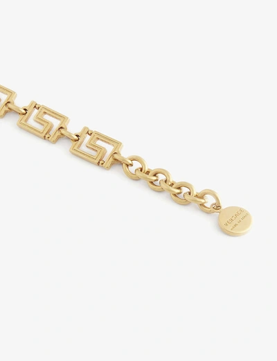 Shop Versace Grecamania Logo-engraved Bracelet In Tribute Gold