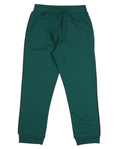 Shop Touriste Casual Pants In Emerald Green