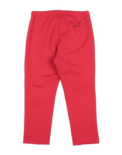 Shop Touriste Pants In Red