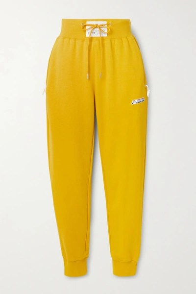 Shop Adam Selman Sport Cotton-blend Jersey Track Pants In Mustard