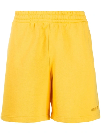 Shop Adidas Originals By Pharrell Williams X Pharrell Williams Embroidered Logo Track Shorts In Yellow