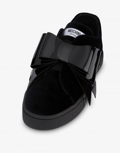 Shop Moschino Slip On Sneakers In Velvet Maxi Bow In Black