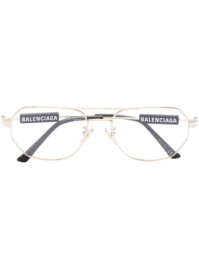 Shop Balenciaga Tag Pilot-frame Glasses In Gold