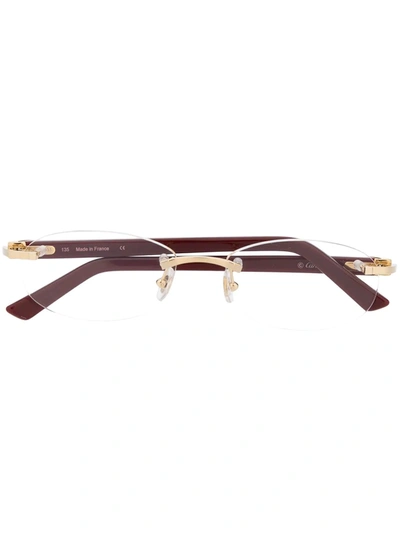 Shop Cartier Rimless Oval Optical Glasses In Red