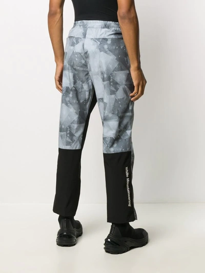 Shop White Mountaineering X Colman Age Geometric Print Trousers In Grey