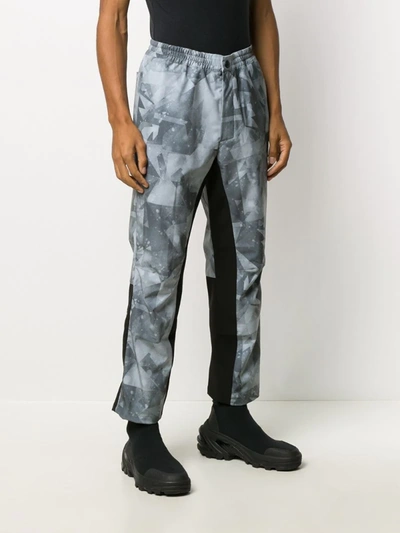 Shop White Mountaineering X Colman Age Geometric Print Trousers In Grey