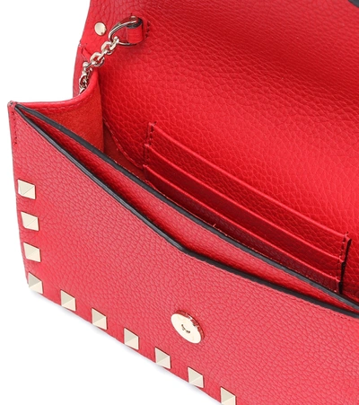 Shop Valentino Rockstud Small Leather Clutch In Red