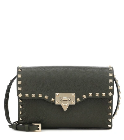 Shop Valentino Rockstud Small Leather Clutch In Green
