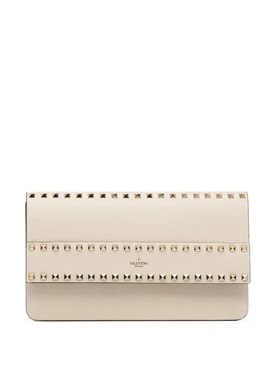 Shop Valentino Rockstud Leather Clutch Bag In Neutrals