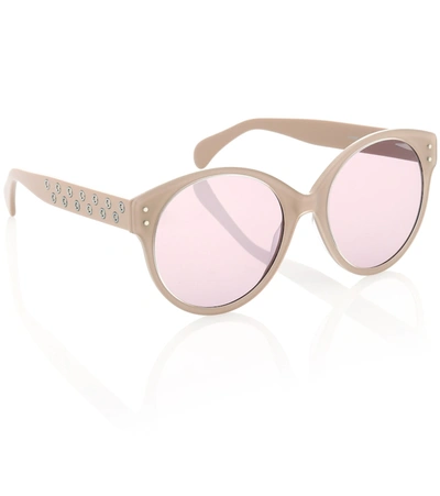 Shop Alaïa Round Sunglasses In Beige