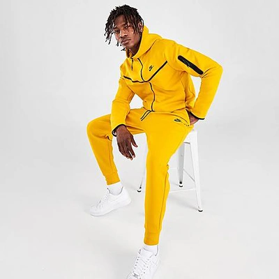 Shop Nike Tech Fleece Taped Jogger Pants In Yellow