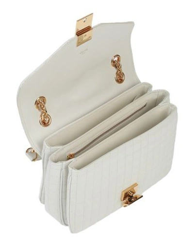 Shop Celine Handbags In White