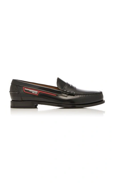 Shop Prada Logo-appliquéd Leather Penny Loafers In Black