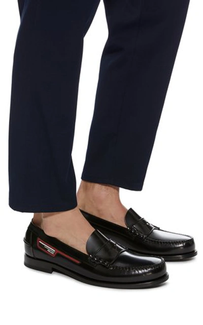 Shop Prada Logo-appliquéd Leather Penny Loafers In Black