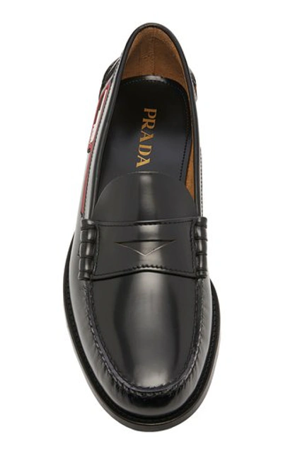 Shop Prada Logo-appliquéd Leather Penny Loafers In Black