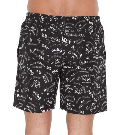 Shop Dolce & Gabbana All Over Logo Print Swim Trunks In Black