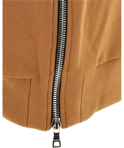 Shop Balmain Logo Embossed Hoodie In Brown