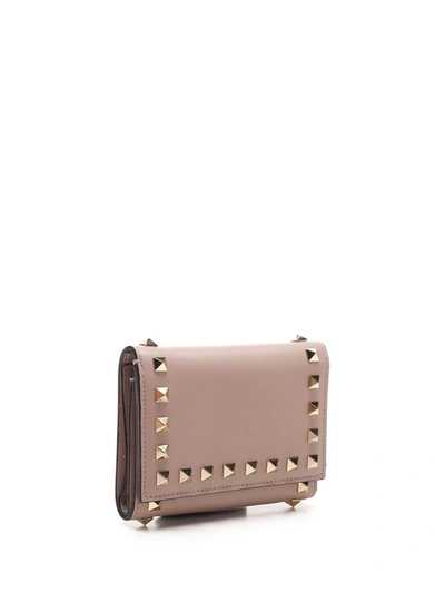 Shop Valentino Garavani Rockstud Trifold Wallet In Beige