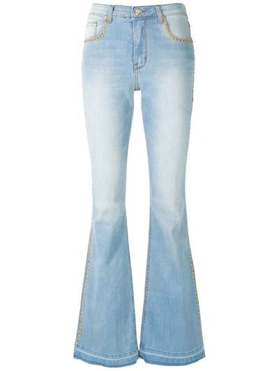 Shop Amapô Flared Denim Trousers With Studs In Blue